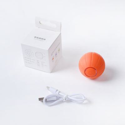 Orange smart bouncing rolling silicone ball toy for cats, shown with its white packaging box and a white USB charging cable. - Image 6