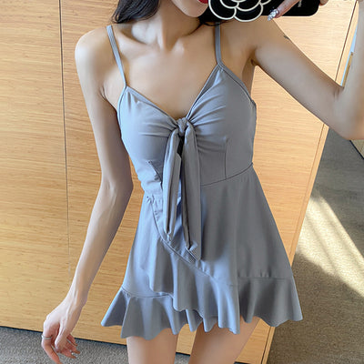 Women's light blue one-piece swimsuit with tie-front bust and ruffled hem, paired with a sheer shimmery cover-up. - Image 3