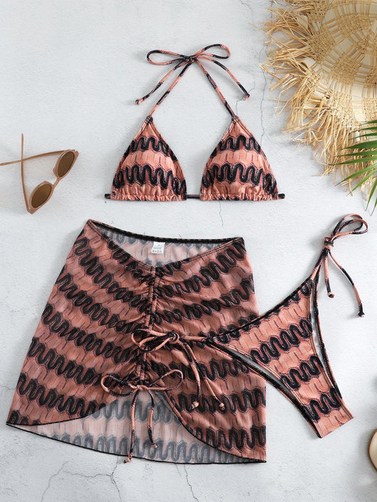 Three-piece printed swimsuit with a red and teal abstract pattern, featuring a halter bikini top, bottom, and mesh wrap skirt with drawstring. - Image 13