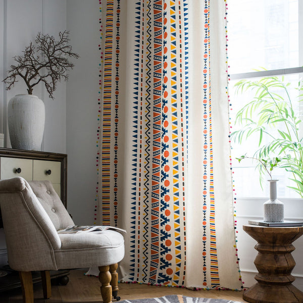 Bohemian cotton and linen curtain with colorful geometric prints and fur ball trim, hanging in a bright room. - Image 3