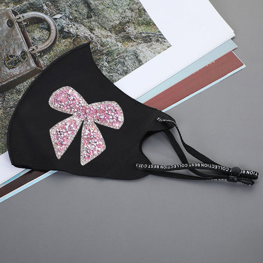 Black ear-mounted mask with a sparkling rhinestone bow pattern, featuring adjustable ear loops. - Image 18