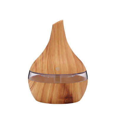 Teardrop-shaped humidifier with light wood grain finish and clear water tank, featuring a power button icon. - Image 9