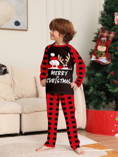 Family of four wearing matching red and black buffalo plaid Christmas pajamas with reindeer graphic. - Image 9