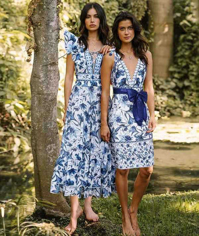 Women's blue and white floral one-piece swimsuit with ruffled V-neck and matching sarong skirt with bow. - Image 25