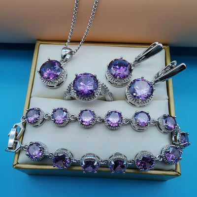 Four-piece silver-tone jewelry set with round green gemstones, including a necklace, bracelet, ring, and dangle earrings. - Image 7