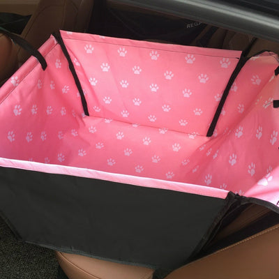 Brown pet car mat with colorful dog pattern installed in a car's rear seat, protecting upholstery. - Image 9