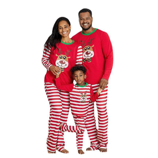 Young boy wearing a red and white striped long-sleeved pajama set with a reindeer graphic on the chest.