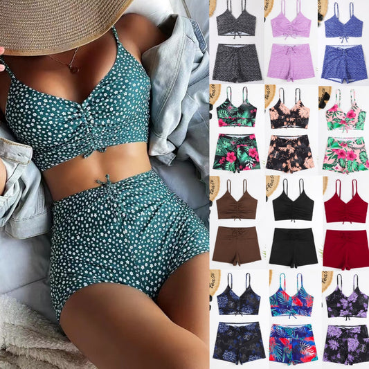 Blue two-piece swimsuit with white floral print, featuring a ruched crop top and matching boxer shorts.