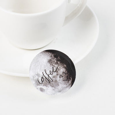 Circular black and white stickers depicting various moon phases, with a small black sticker box on a white background. - Image 6