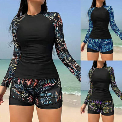 Women's long-sleeve tankini swimsuit with black top and blue tropical leaf print raglan sleeves, matching swim shorts. - Image 14