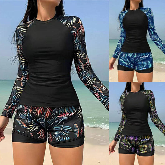 Women's long-sleeve tankini swimsuit with black top and blue tropical leaf print raglan sleeves, matching swim shorts. - Image 14