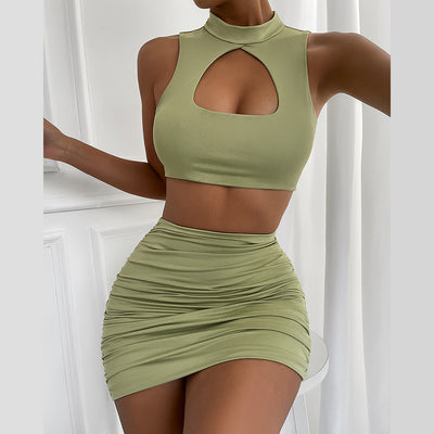 Light green two-piece set featuring a sleeveless crop top with a high neck and chest cutout, paired with a ruched bodycon mini skirt. - Image 4