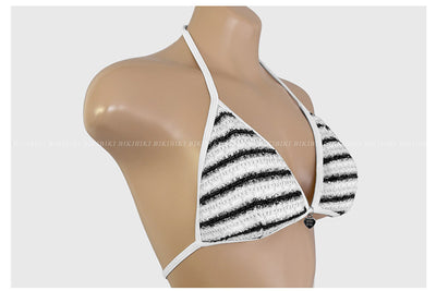 White and black striped bikini with triangle-cut top and tie-side bottom, modeled outdoors. - Image 32