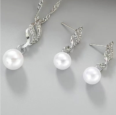 Gold-tone necklace and dangle earring set with faux pearls and clear rhinestones, displayed on a black bust. - Image 6