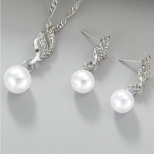 Gold-tone necklace and dangle earring set with faux pearls and clear rhinestones, displayed on a black bust. - Image 6
