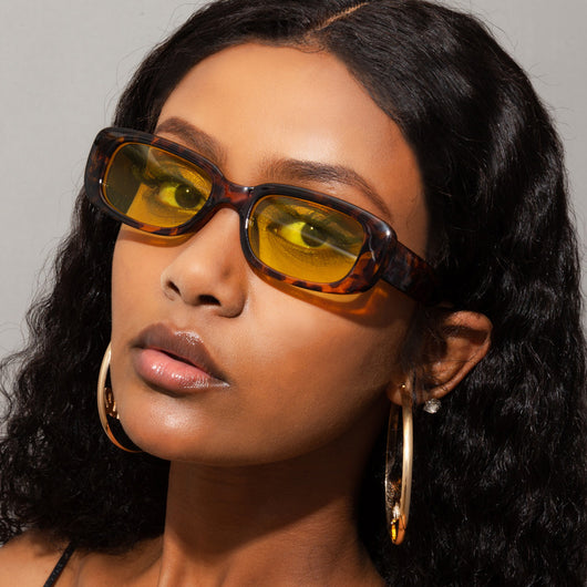 Rectangular tortoiseshell sunglasses with a small frame and dark gray lenses, angled on a white background. - Image 29