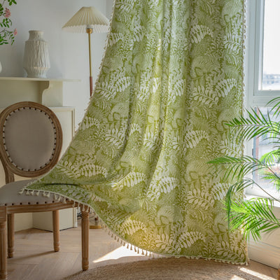 Green curtain with white leafy botanical pattern and cream tassels, hanging in a window with natural light. - Image 2