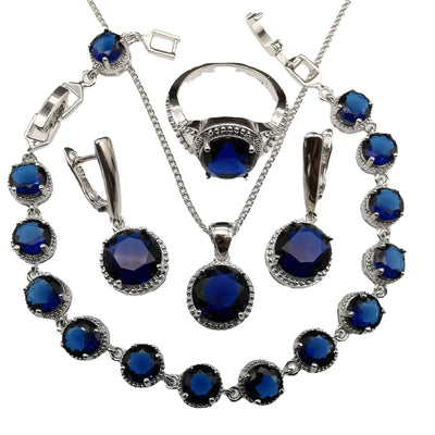 Four-piece silver-tone jewelry set with round green gemstones, including a necklace, bracelet, ring, and dangle earrings. - Image 5