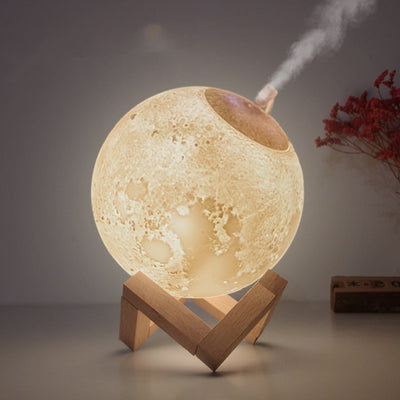 Moon-shaped humidifier and night light with a white deer stand, emitting mist, on a wooden table with books. - Image 4
