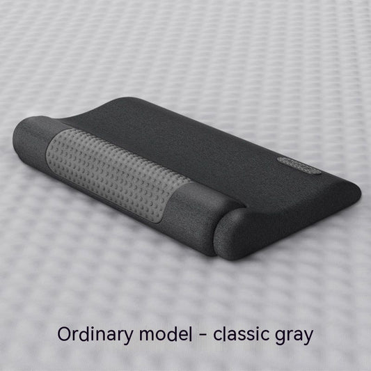 Dark gray cervical spine pillow with light gray textured massage area and power button on a light gray surface. - Image 2