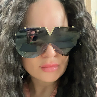 Oversized V-shaped sunglasses with a gold metal frame, white accents, clear lenses, and decorative rivets. - Image 4