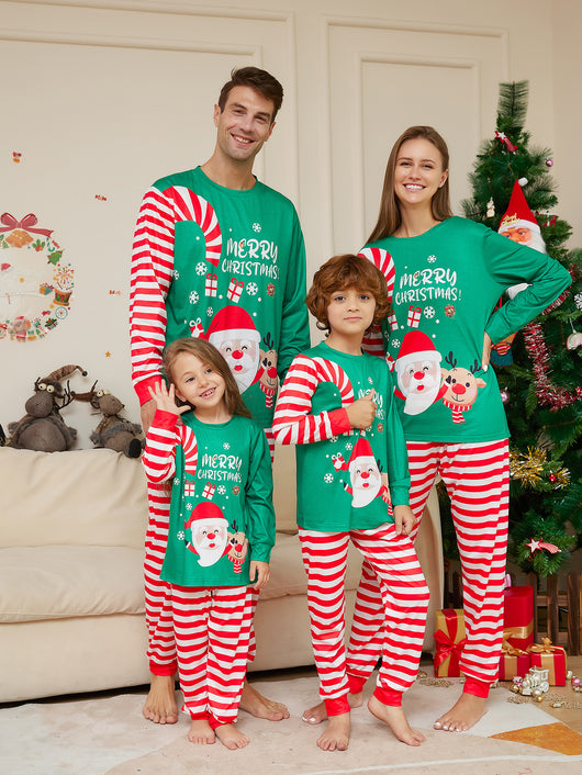 Family of four wearing matching green Christmas pajamas with Santa, reindeer, and red and white striped pants. - Image 6