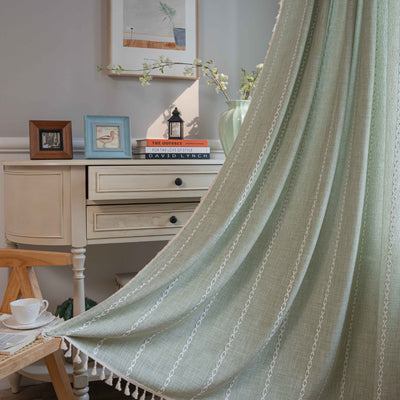 Black polyester curtain with white jacquard multi-line pattern and black tassels, draped over a white chair. - Image 8