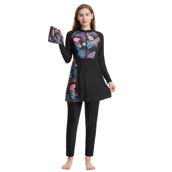 Woman in a navy blue quick-drying conservative swimwear set with a tropical leaf print tunic and matching swim cap. - Image 6