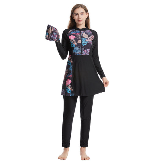 Woman in a navy blue quick-drying conservative swimwear set with a tropical leaf print tunic and matching swim cap. - Image 6