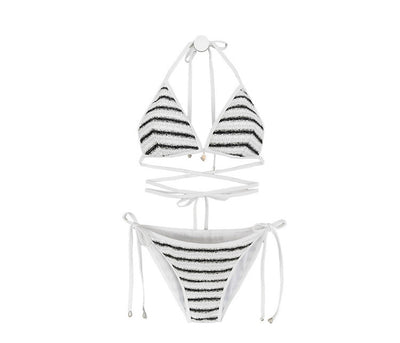 White and black striped bikini with triangle-cut top and tie-side bottom, modeled outdoors. - Image 17