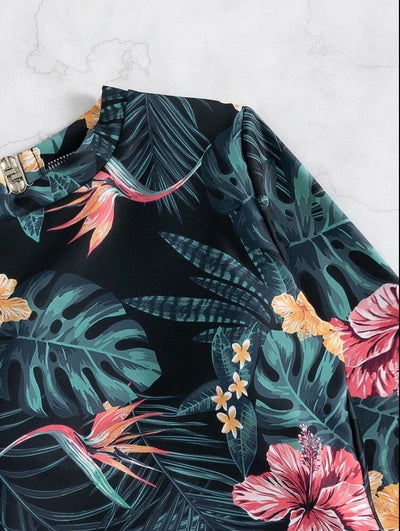 Women's pink long-sleeve one-piece swimsuit with a vibrant tropical leaf and floral print. - Image 16