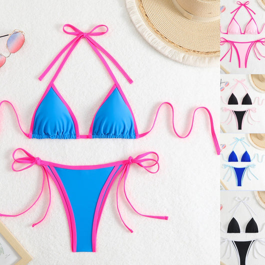 Royal blue two-piece bikini with light blue trim and tie straps, laid flat on a white textured surface.