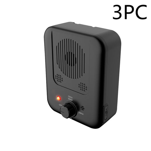 Black ultrasonic anti-barking device with a red light and a control knob, next to yellow pet goggles with rainbow lenses. - Image 7