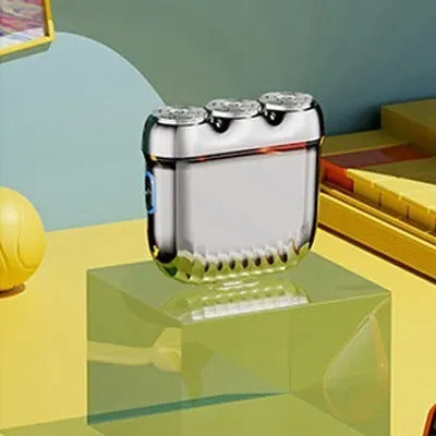 Orange mini electric shaver with three silver floating cutter heads, a blue power button, on a translucent orange block. - Image 7