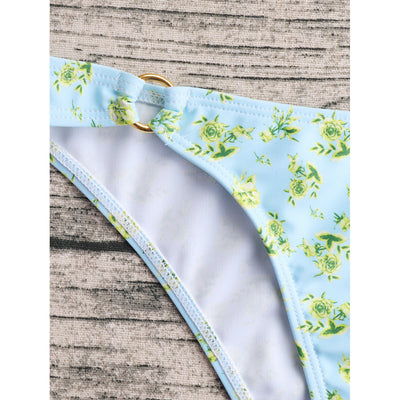 Woman smiling in a white bikini with blue floral print, triangle top, and briefs bottoms, on a sunny beach. - Image 38