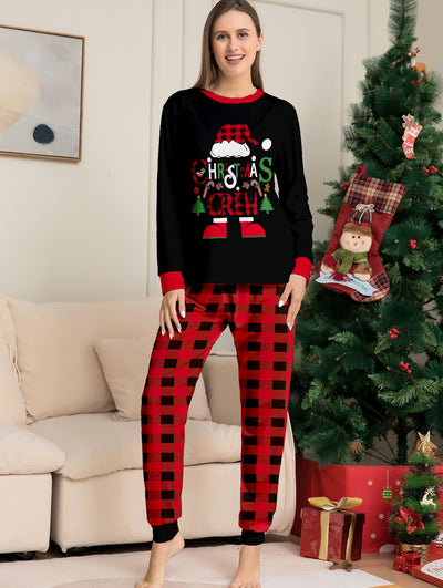 Man wearing black and red plaid Christmas pajamas with a Santa graphic top and matching pants. - Image 5