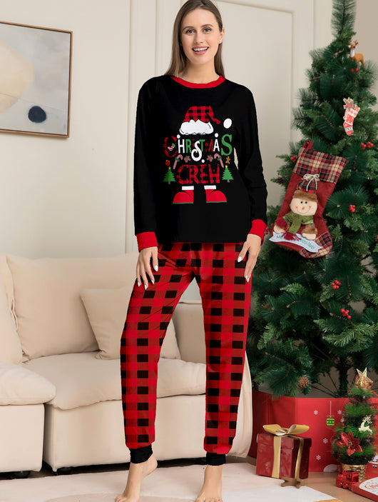 Man wearing black and red plaid Christmas pajamas with a Santa graphic top and matching pants. - Image 18