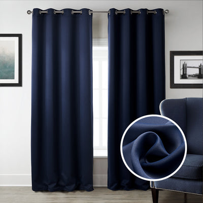 Dark blue blackout curtains with silver grommet tops hanging on a rod in a modern bedroom setting. - Image 8