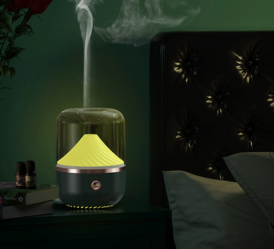 Dark green aromatherapy machine with a transparent top, yellow spiral diffuser, and copper trim. - Image 6