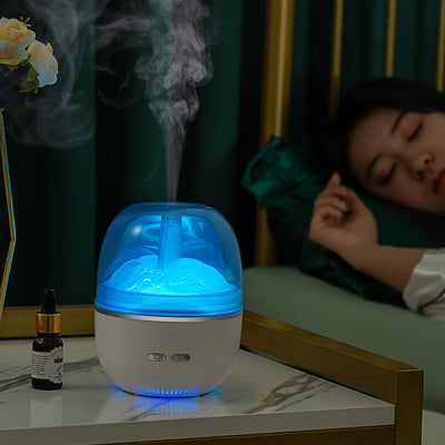 White essential oil diffuser and humidifier with a clear dome top, glowing red inside, and blue LED base light. - Image 6