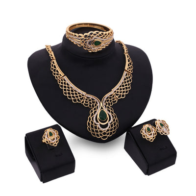 Four-piece gold-tone jewelry set with green teardrop accents and clear rhinestones, including a necklace, bracelet, earrings, and ring. - Image 6