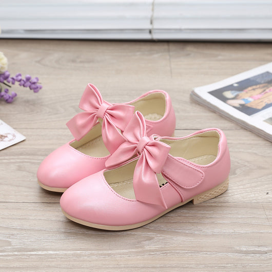 Gold Mary Jane shoes for girls with a large decorative bow on the strap and a low, comfortable heel. - Image 10