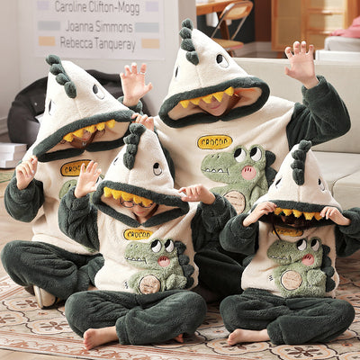 Family wearing matching black and white panda plush housewear suits with hoods and checkered pants, posing indoors. - Image 5
