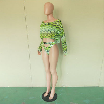 Woman in a purple and pink snakeskin print three-piece swimsuit with an off-shoulder crop top and high-waisted bottoms. - Image 18