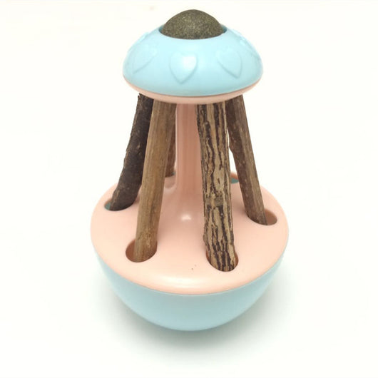 Pink tumbler cat toy with a green catnip ball on top and several natural wooden sticks for chewing. - Image 11