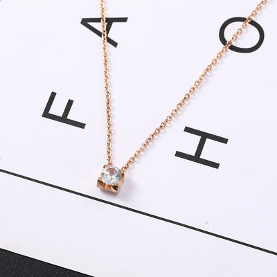 Delicate silver-colored chain necklace with a single square-cut clear stone pendant in a four-prong setting on a woman's neck. - Image 4