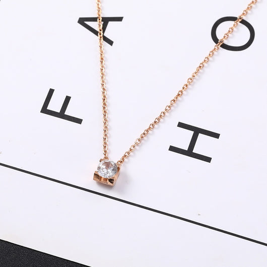 Delicate silver-colored chain necklace with a single square-cut clear stone pendant in a four-prong setting on a woman's neck. - Image 4