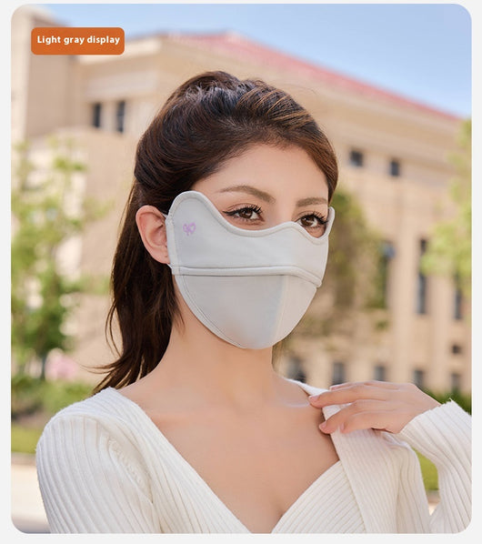 Woman wearing a grey outdoor cycling wind mask with ear hooks and a small heart logo, designed for cold-proof eye protection. - Image 26