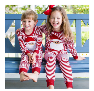 Red and white Christmas pajama set with a long-sleeve top featuring 'Merry Christmas' text and reindeer antlers, paired with striped pants.