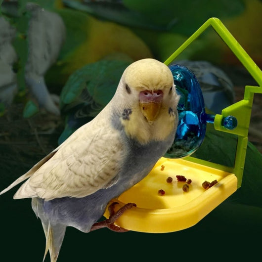 Small blue, yellow, and green parrot food leakage toy with a rotating dispenser and catch tray.